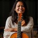 Suhani R. smiling in guitar studio